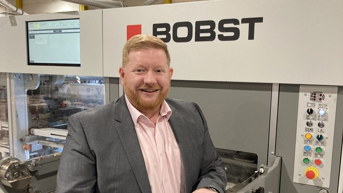 image of CEO, David Cooper, in front of new BOBST machine